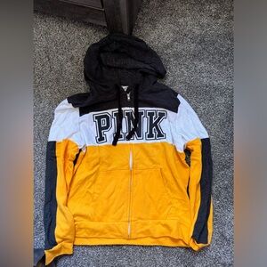 Pink hoodie in a size large! It is black, gold, and white!